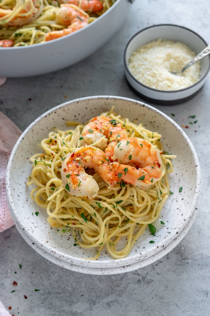 a bowl of pasta with shrimp on top