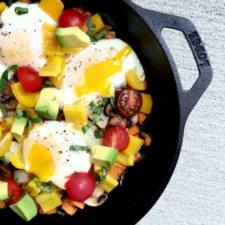 Overhead photo of veggies and eggs in a skillet