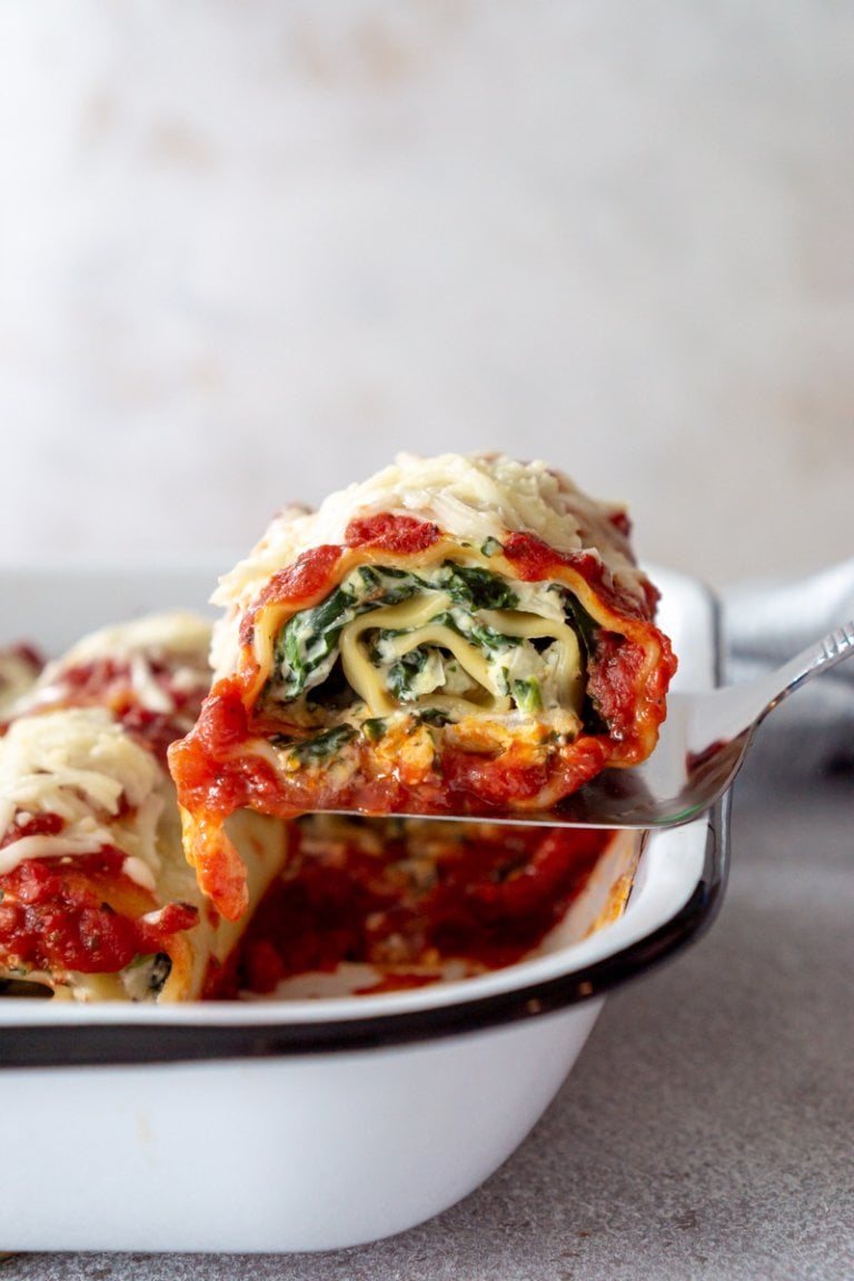 a lasagna roll being served from a pan