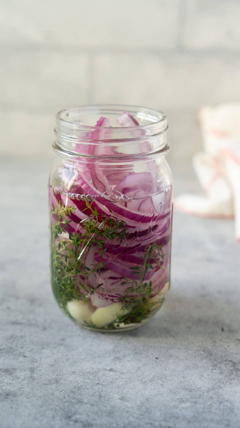 onions, thyme, garlic, and vinegar in a mason jar