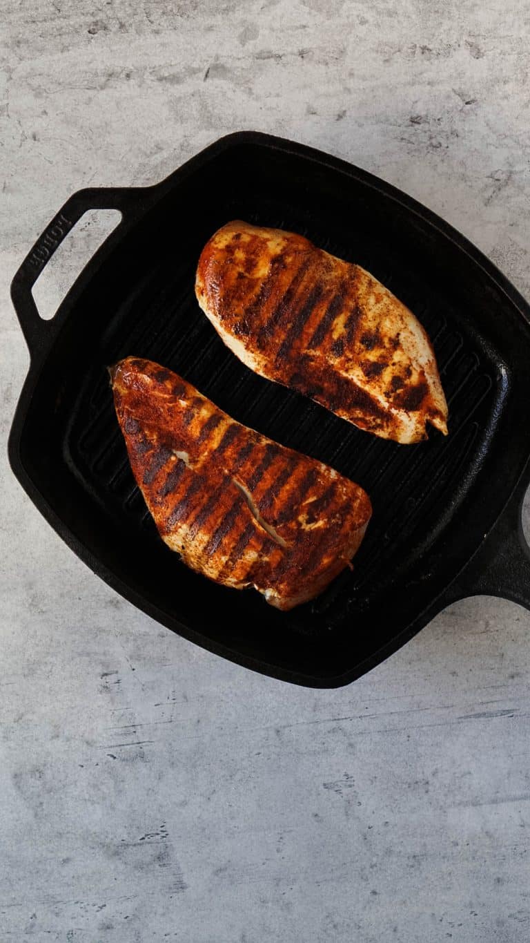 grilled chicken breasts in a cast iron pan