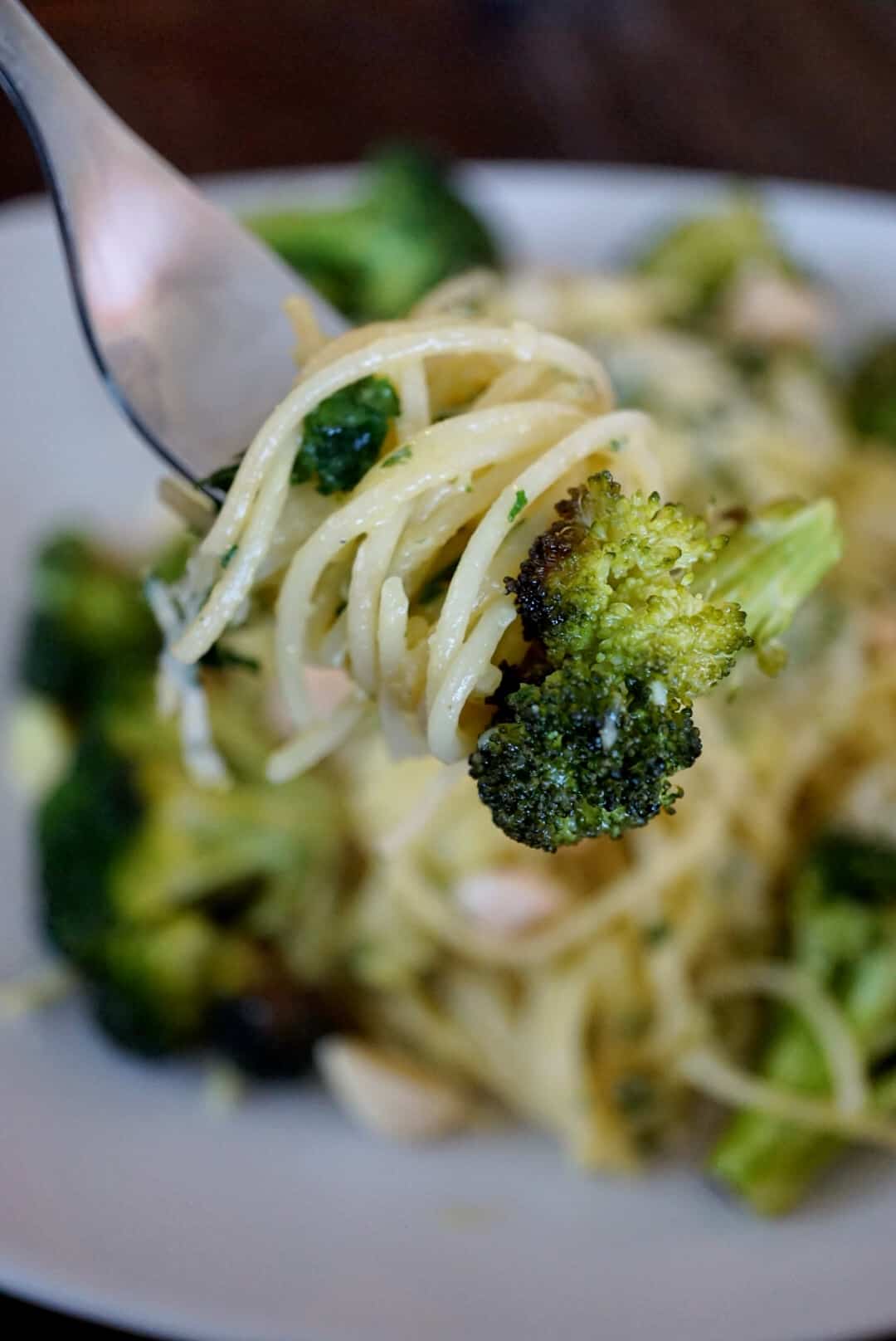 Pasta and broccoli on a silver fork