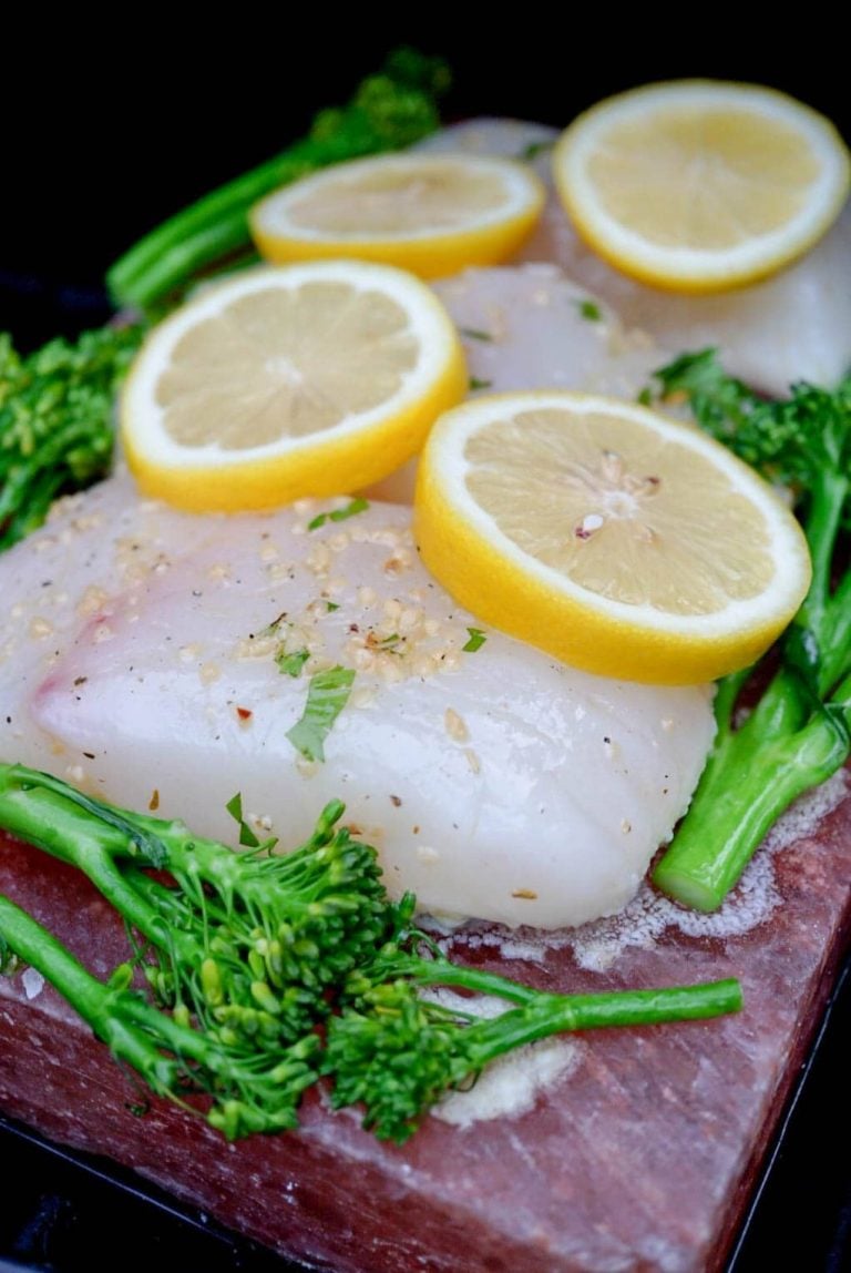 halibut on a salt block with broccolini and lemons