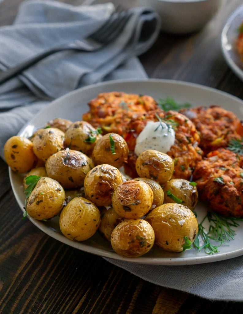 salmon cakes and mini potatoes on a white plate