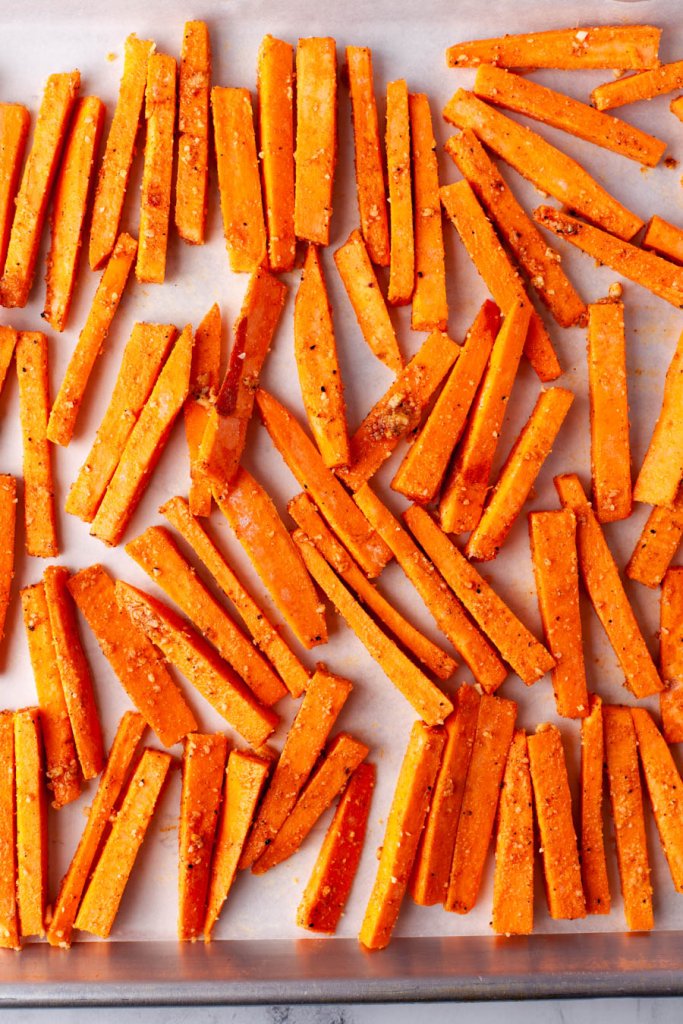 sweet potatoes cut into fries on a baking sheet