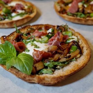 Pesto pita pizza with basil leaves