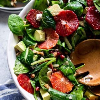 close up of the green salad with a plate off to the side