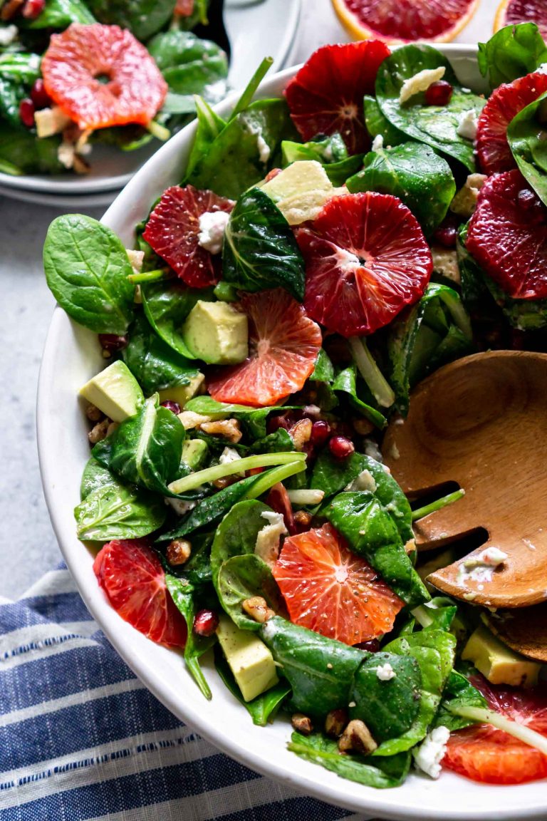 close up of the green salad with a plate off to the side