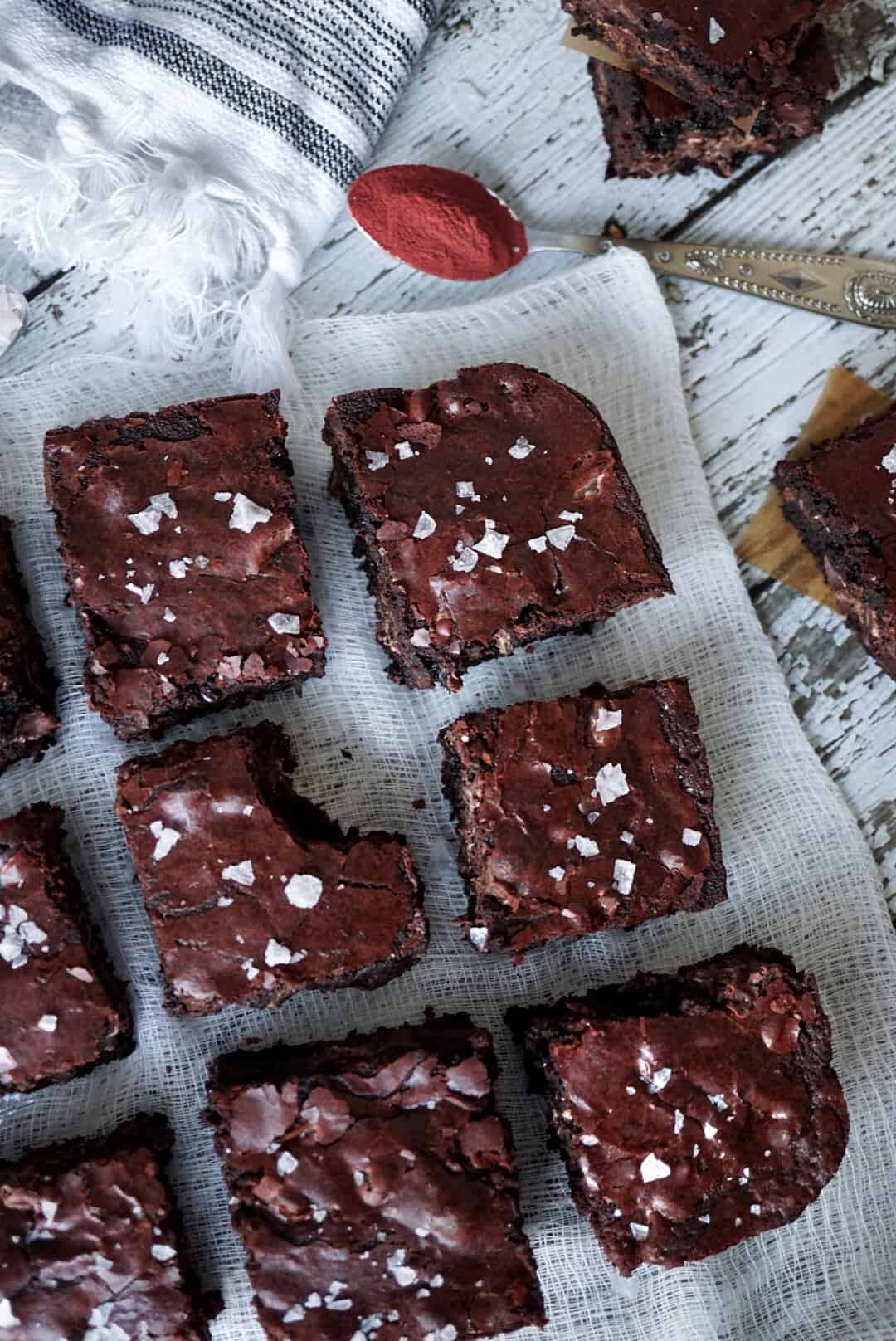 Overhead shot of brownies with a spoon of beetroot powder