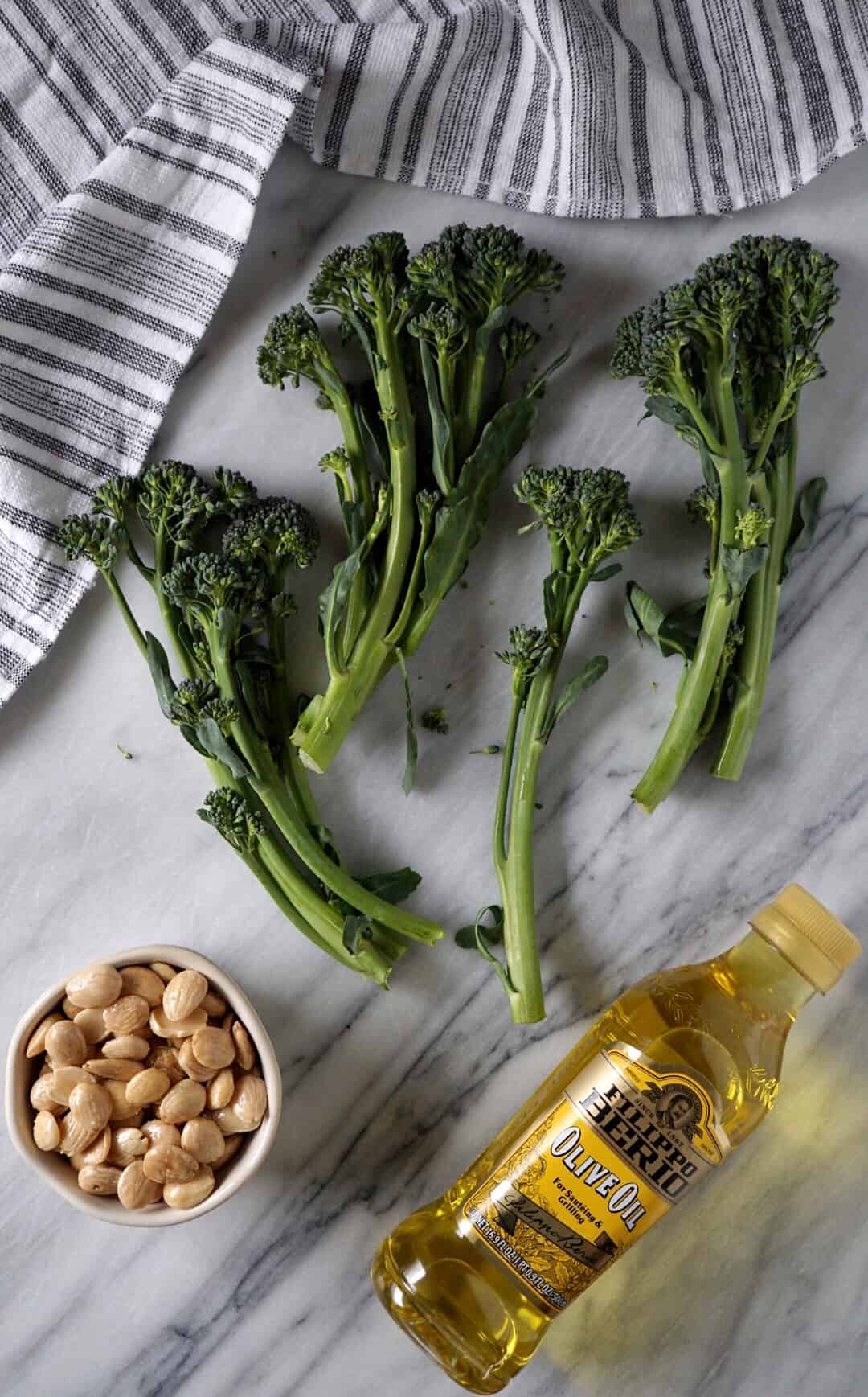 Broccolini, marcona almonds, olive oil, and a dish towel