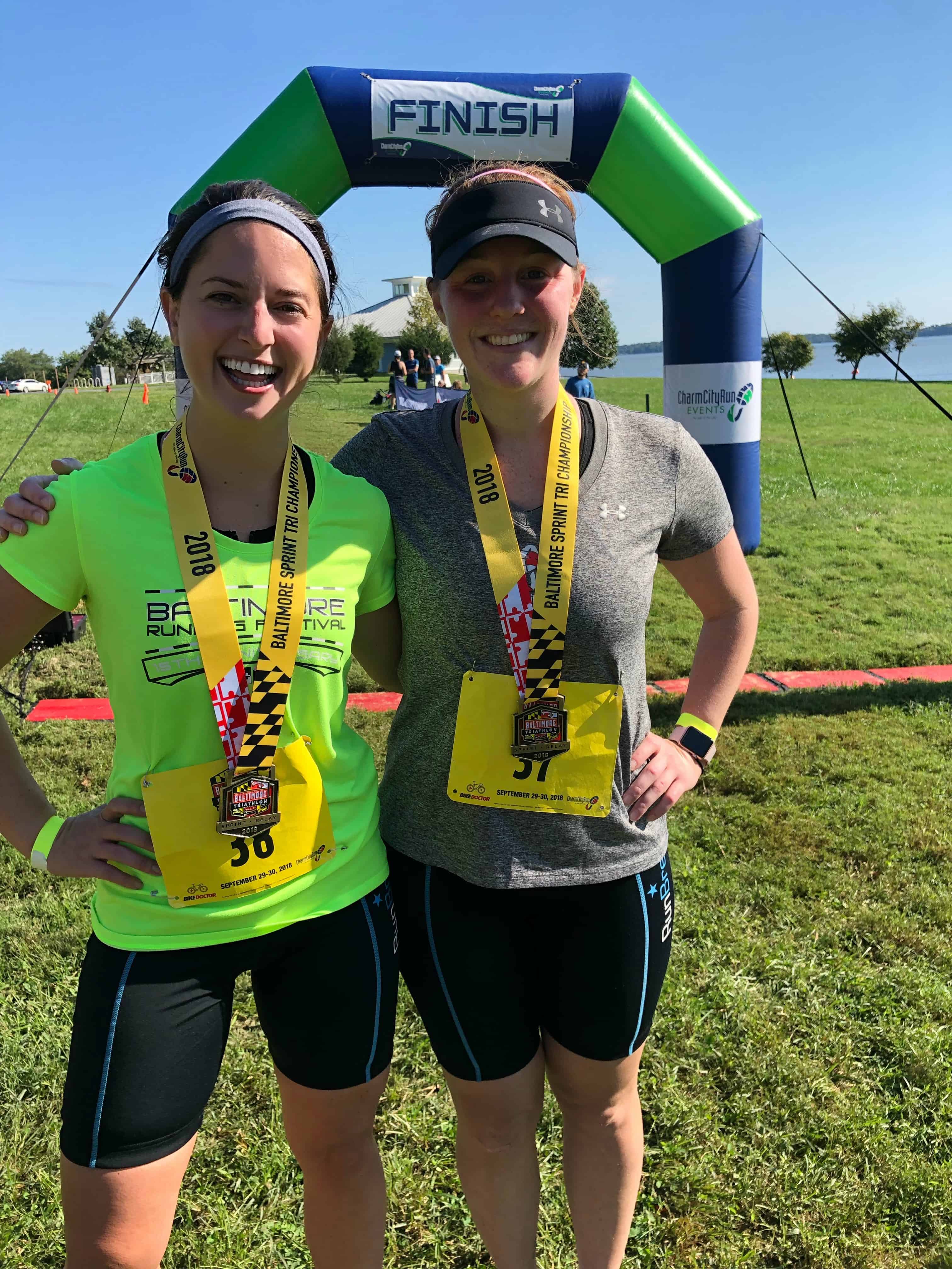 Triathlon - two girls in front of a finish sign