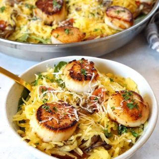 Seared scallops over spaghetti squash in a bowl