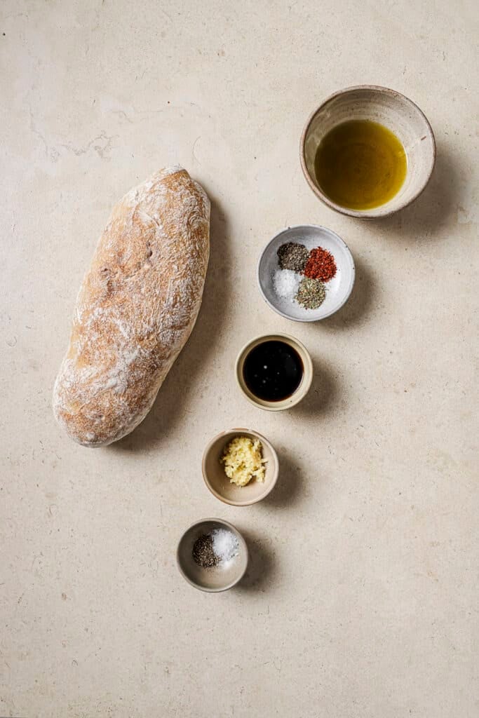 bread, spices, garlic, italian seasoning, olive oil, balsamic vinegar, and salt in small ingredient bowls