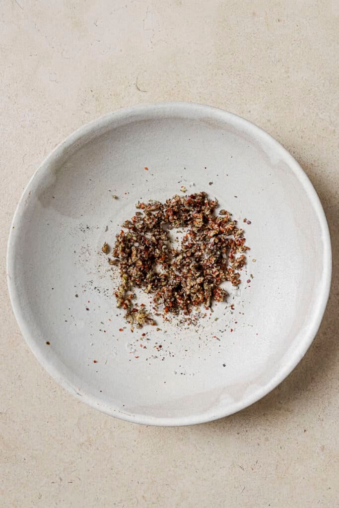 italian seasoning, salt, and spices in a white bowl