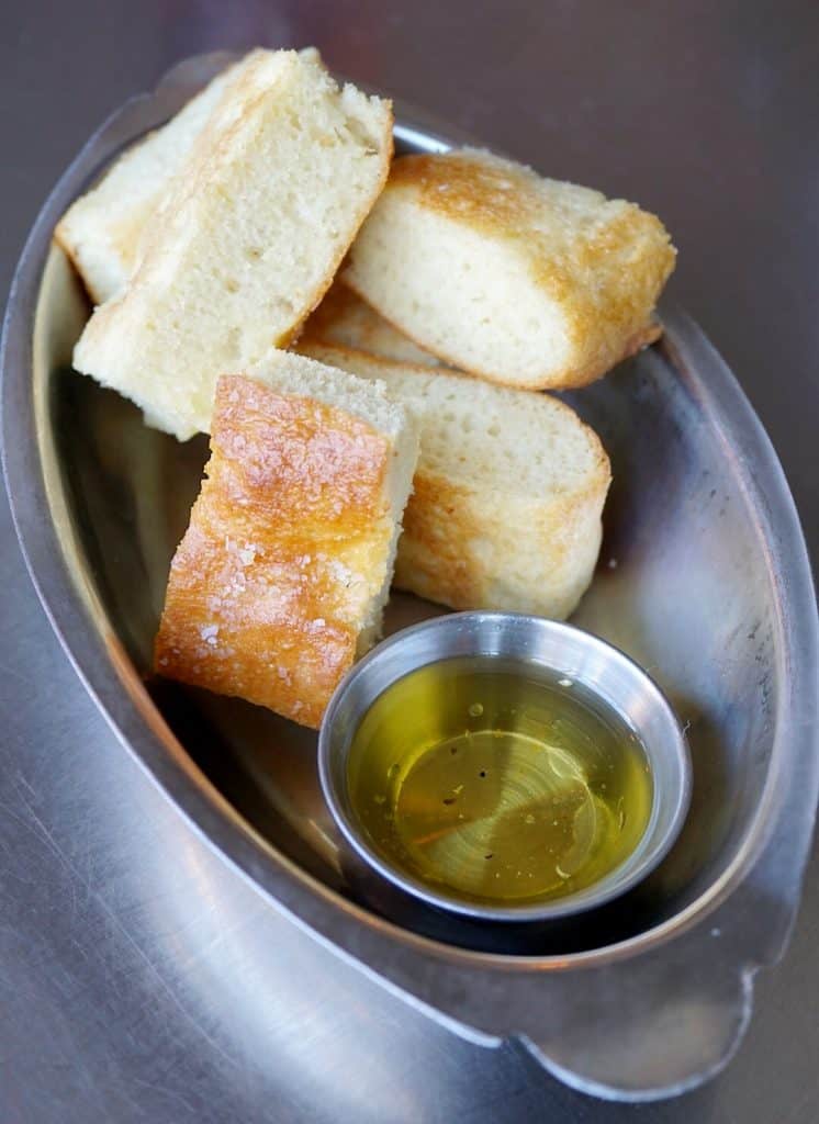 Bread and olive oil in a silver dish