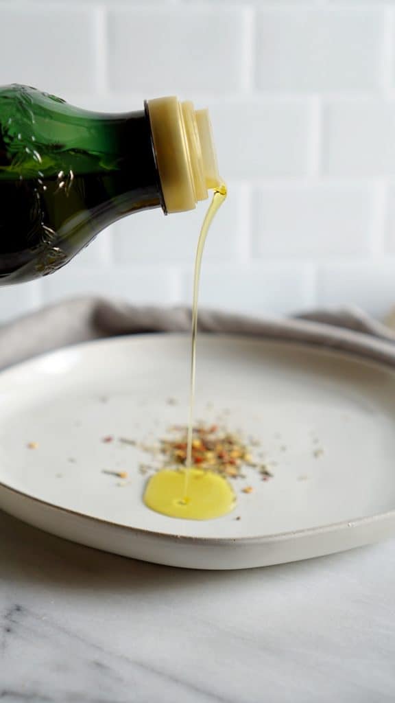 Olive oil being poured on a plate