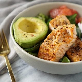 whole30 salmon bowl with gold fork and grey napkin