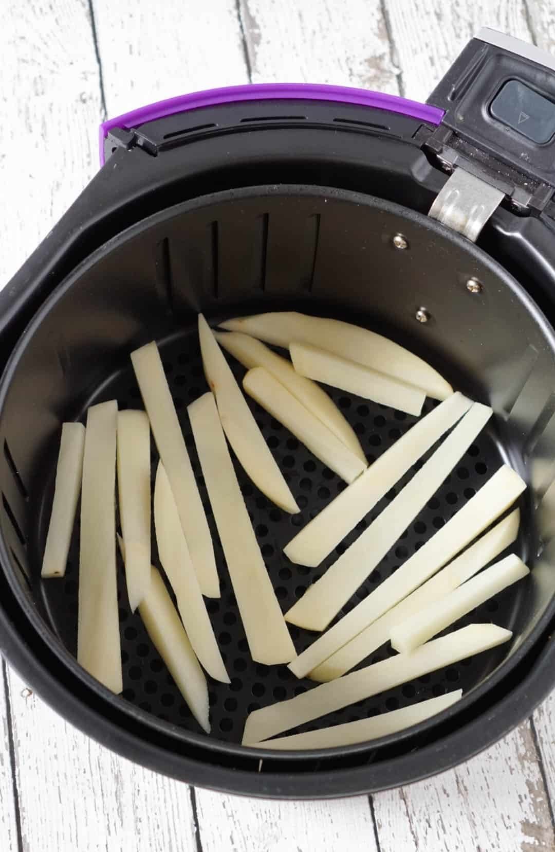 potato fries in an air fryer basket
