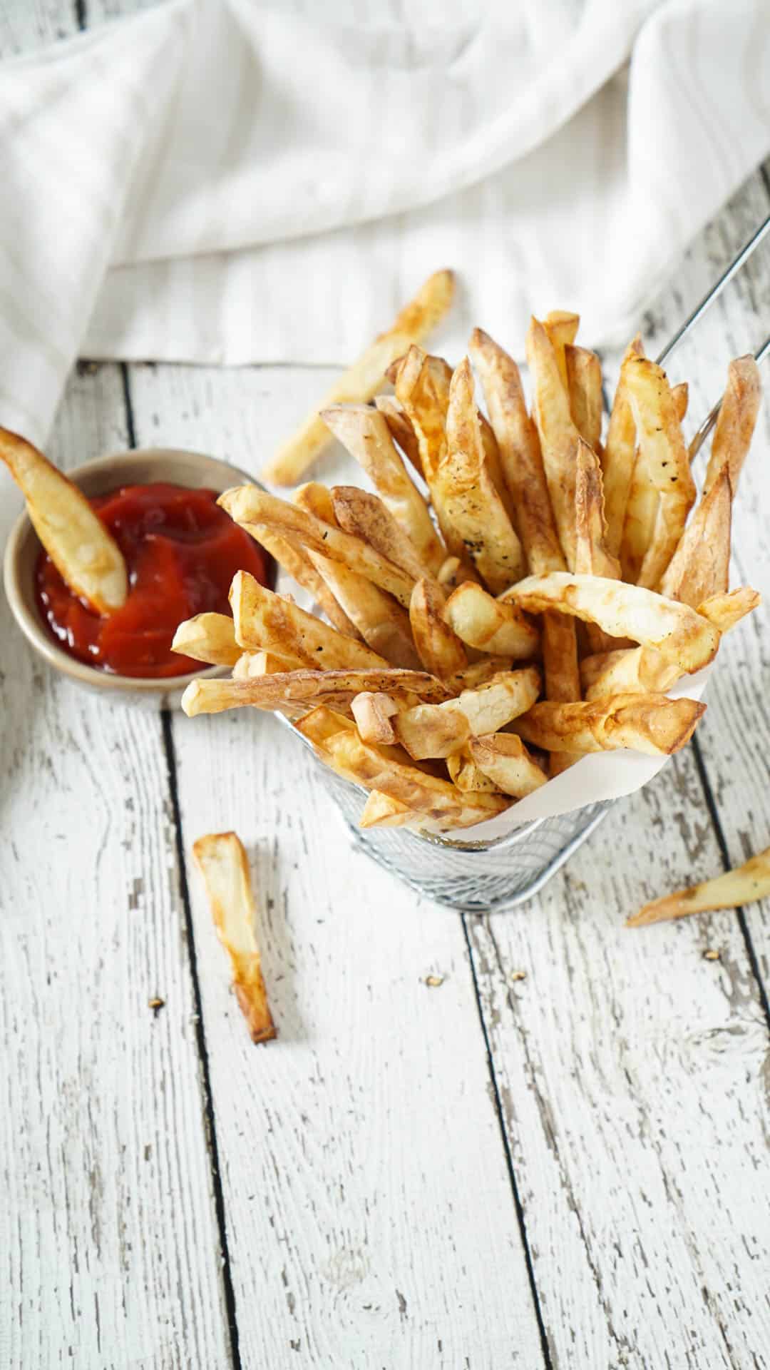 french fries in a basket with ketchup