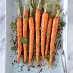 Chili lime roasted carrots on a blue platter