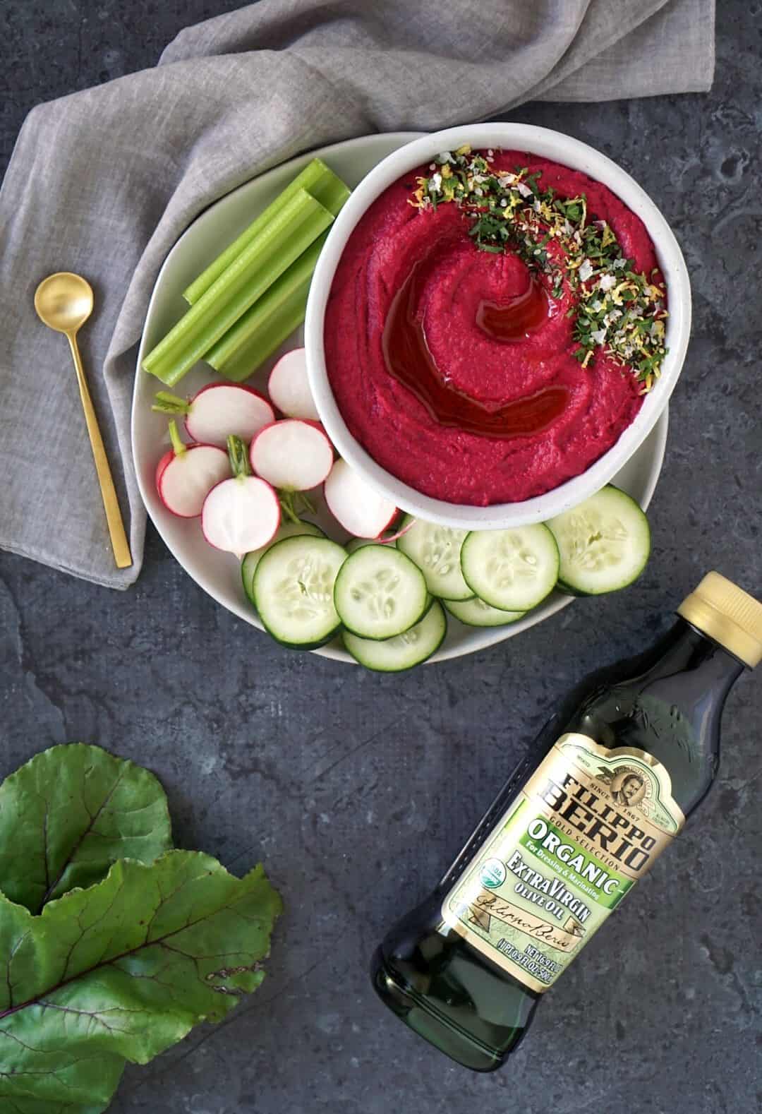 Hummus in a bowl with vegetables on a plate