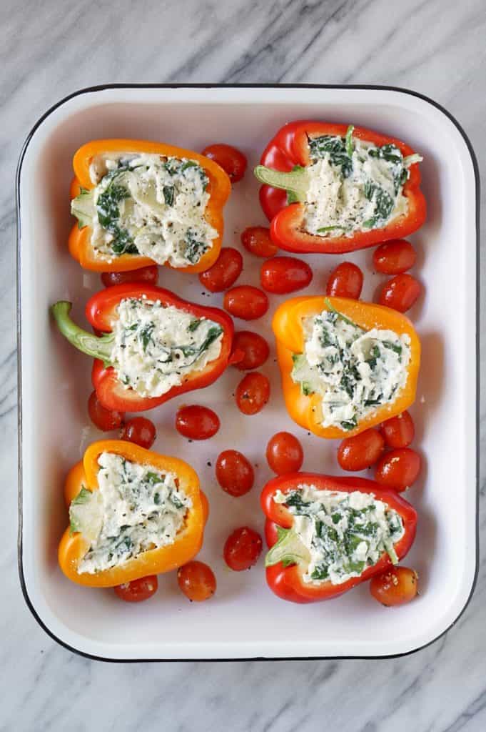 Six vegetarian stuffed peppers in a white pan