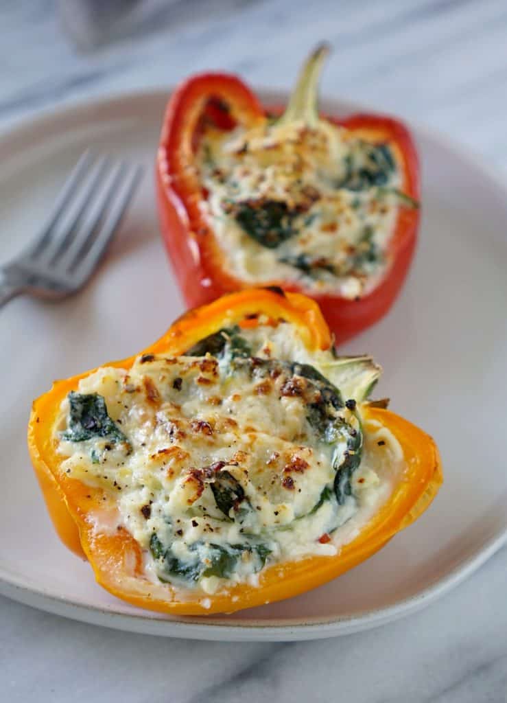 Two vegetarian stuffed peppers on a plate