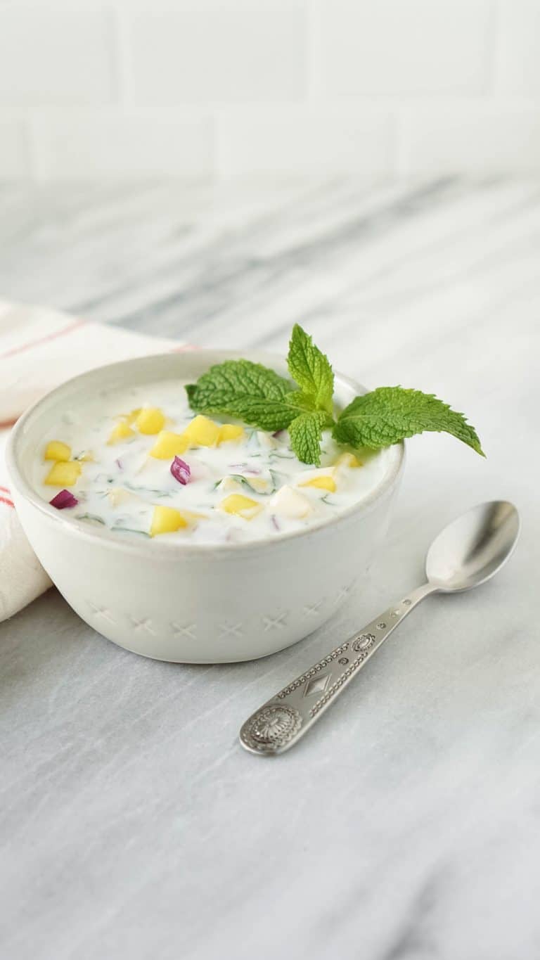 mango yogurt chutney in a small bowl with a spoon