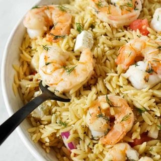 black fork serving garlic butter shrimp with orzo