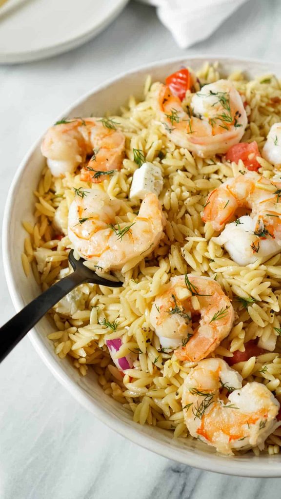 black fork serving garlic butter shrimp with orzo