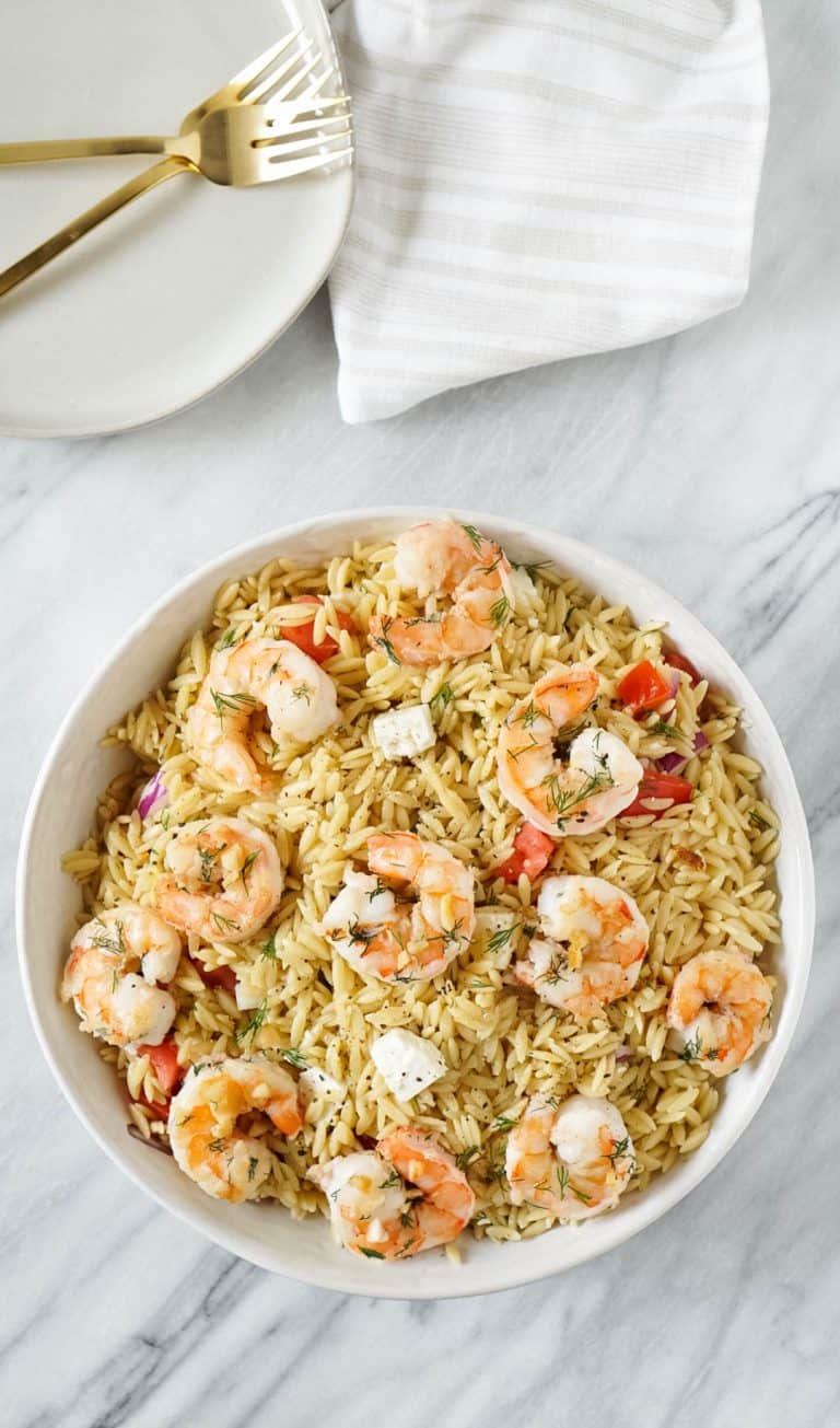 lemon orzo salad with garlic butter shrimp in a large white bowl