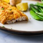 air fryer catfish on a white plate with green beans