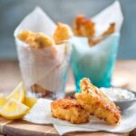 air fryer fish fingers on a wood board