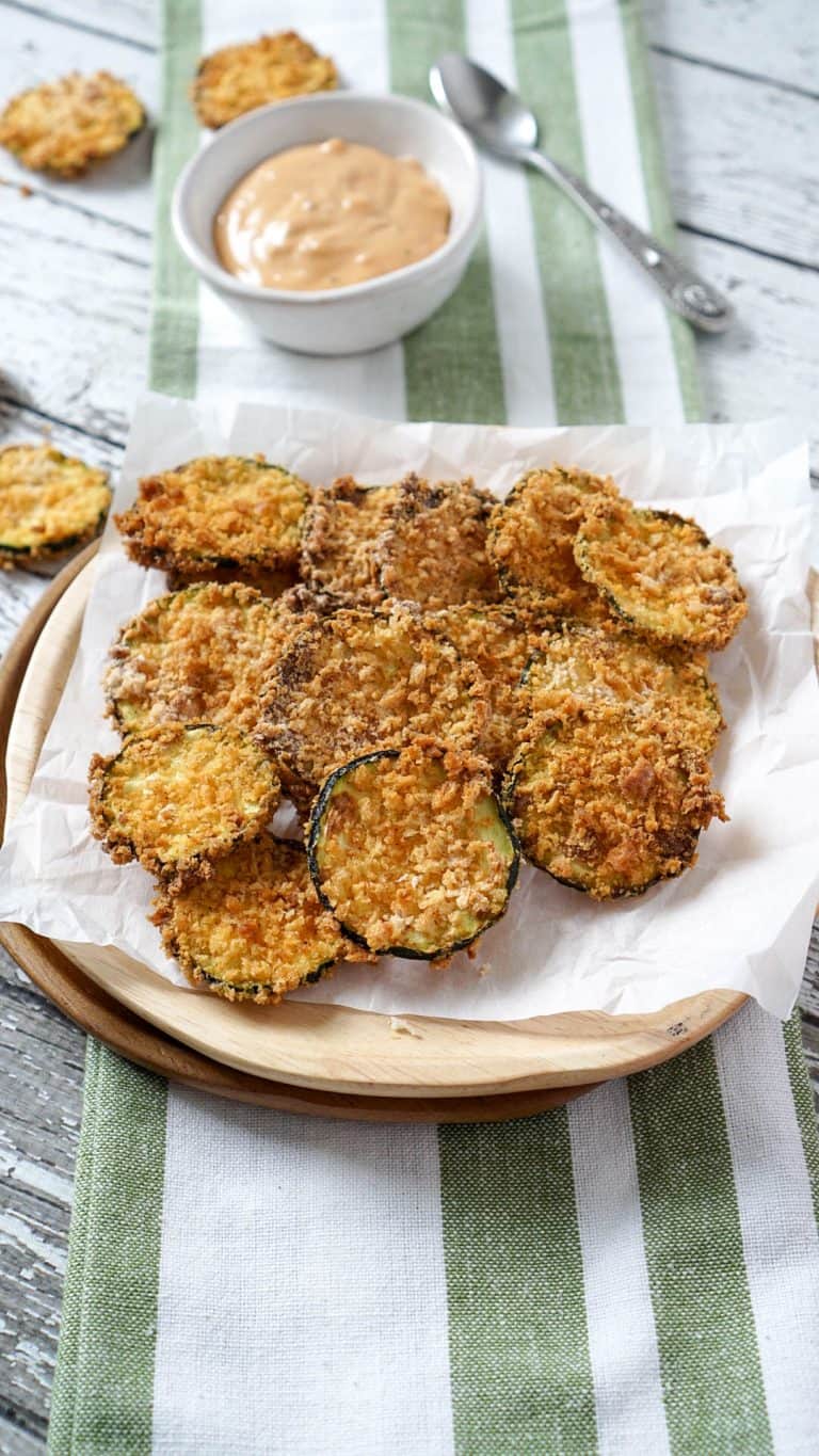air fryer zucchini chips on a plate with a green napkin
