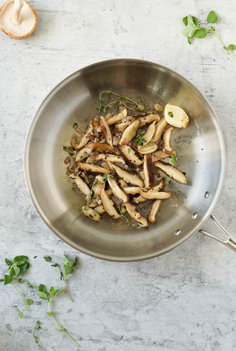 sauteed shiitake mushrooms in a silver pan