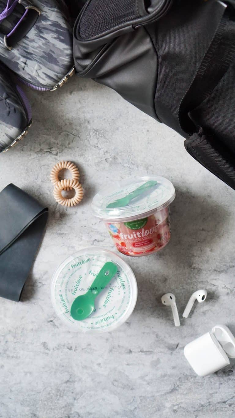 workout essentials - hair ties, headphones, shoes, and a post-workout snack