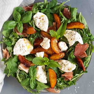 burrata salad on a large plate with a white napkin