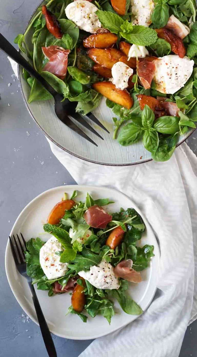 burrata salad on two plates with black forks