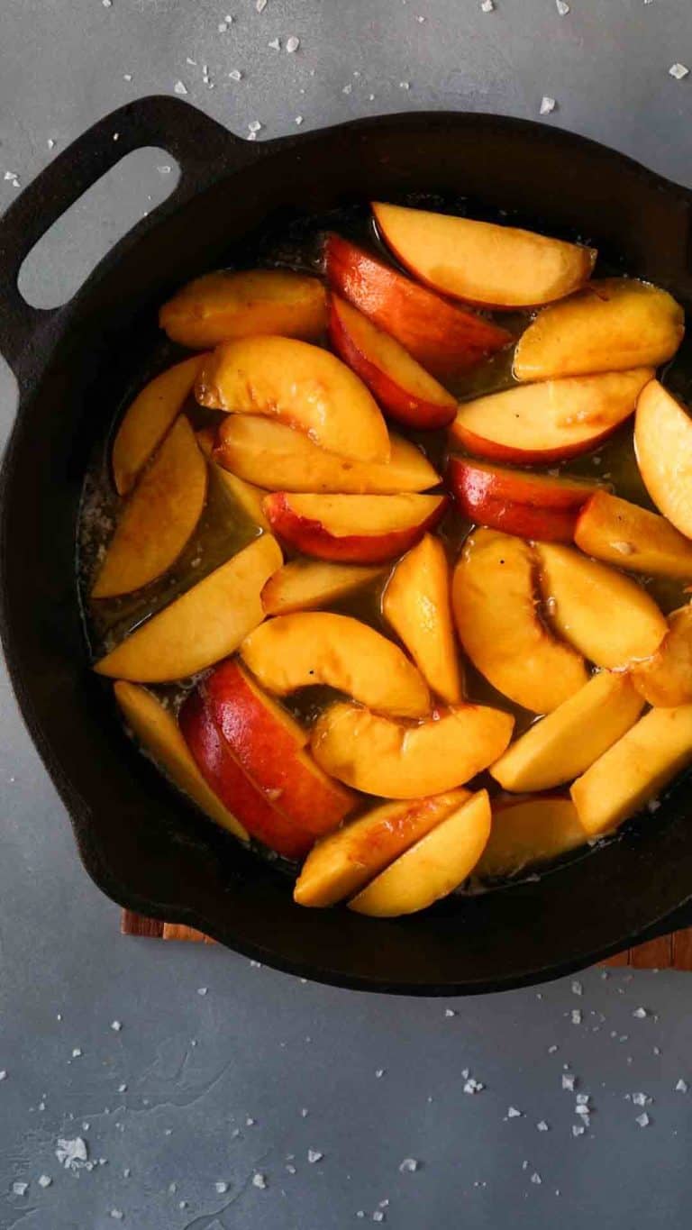Sliced peaches in a cast iron pan