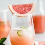 grapefruit margarita in a stemless glass with a grapefruit slice