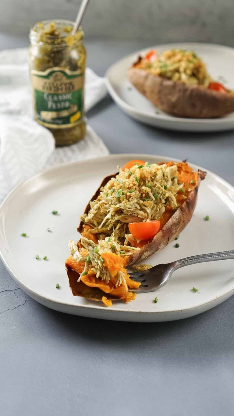 stuffed sweet potato on a white plate with a fork