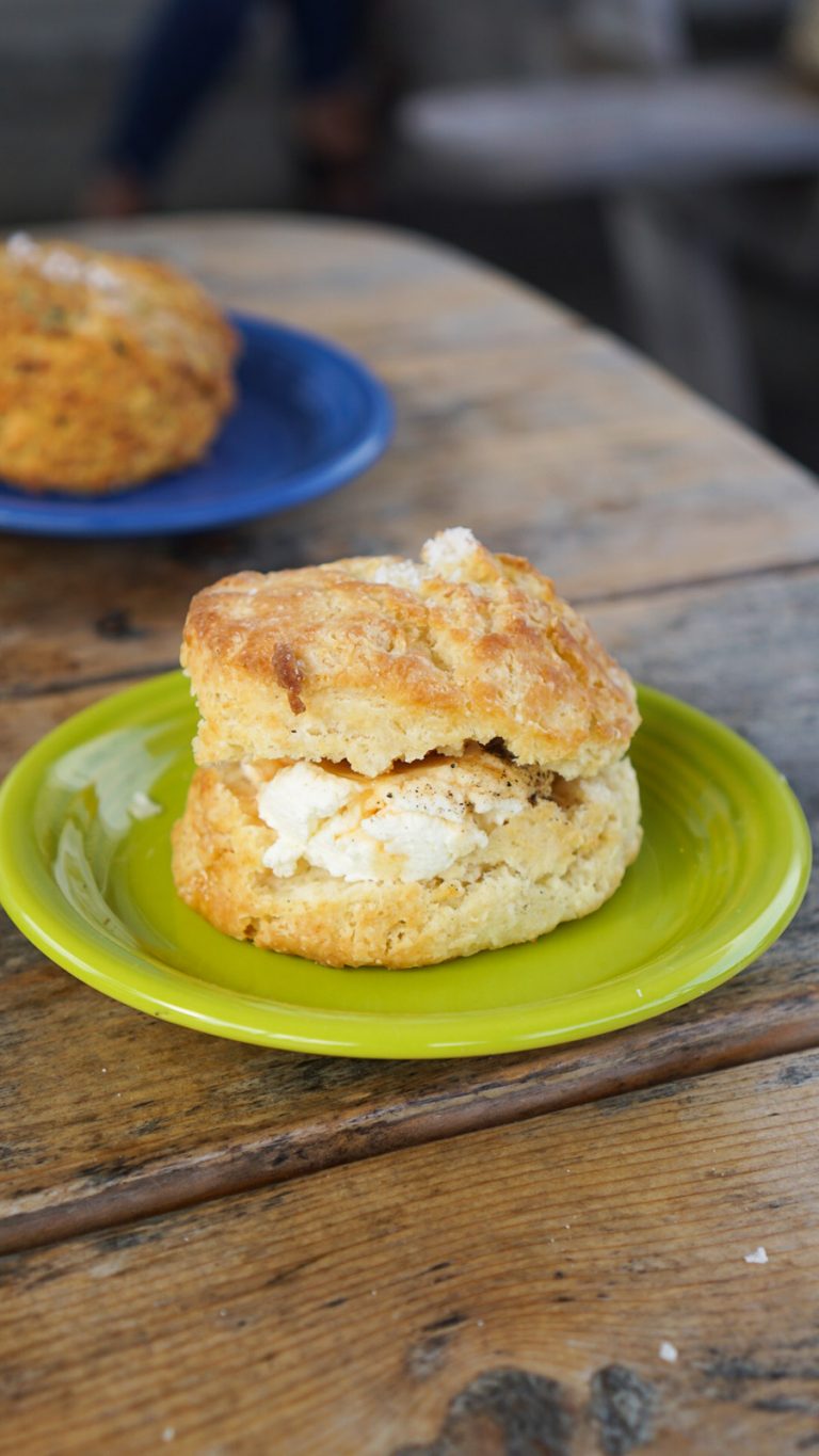 a butter stuffed biscuit on a green plate