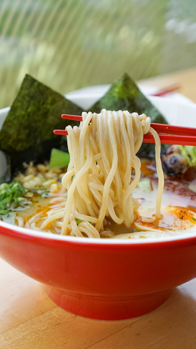 chopsticks lifting ramen noodles