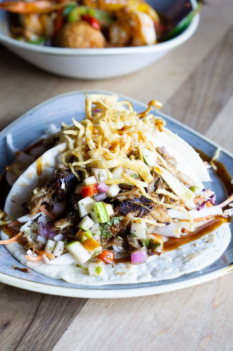 two korean bbq tacos on a plate