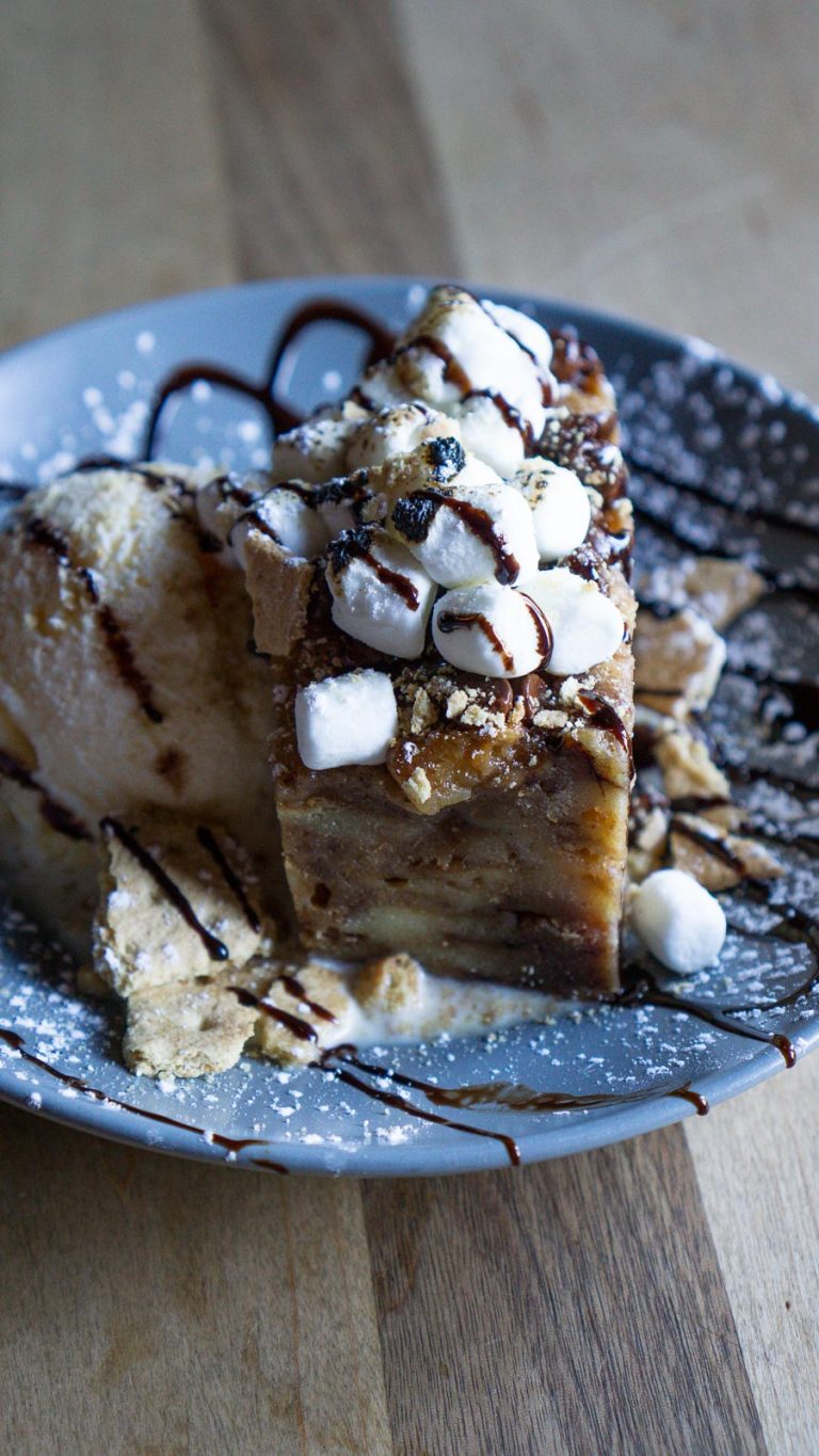 smores bread pudding on a plate with a scoop of ice cream