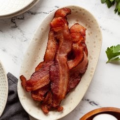air fryer bacon in a white dish