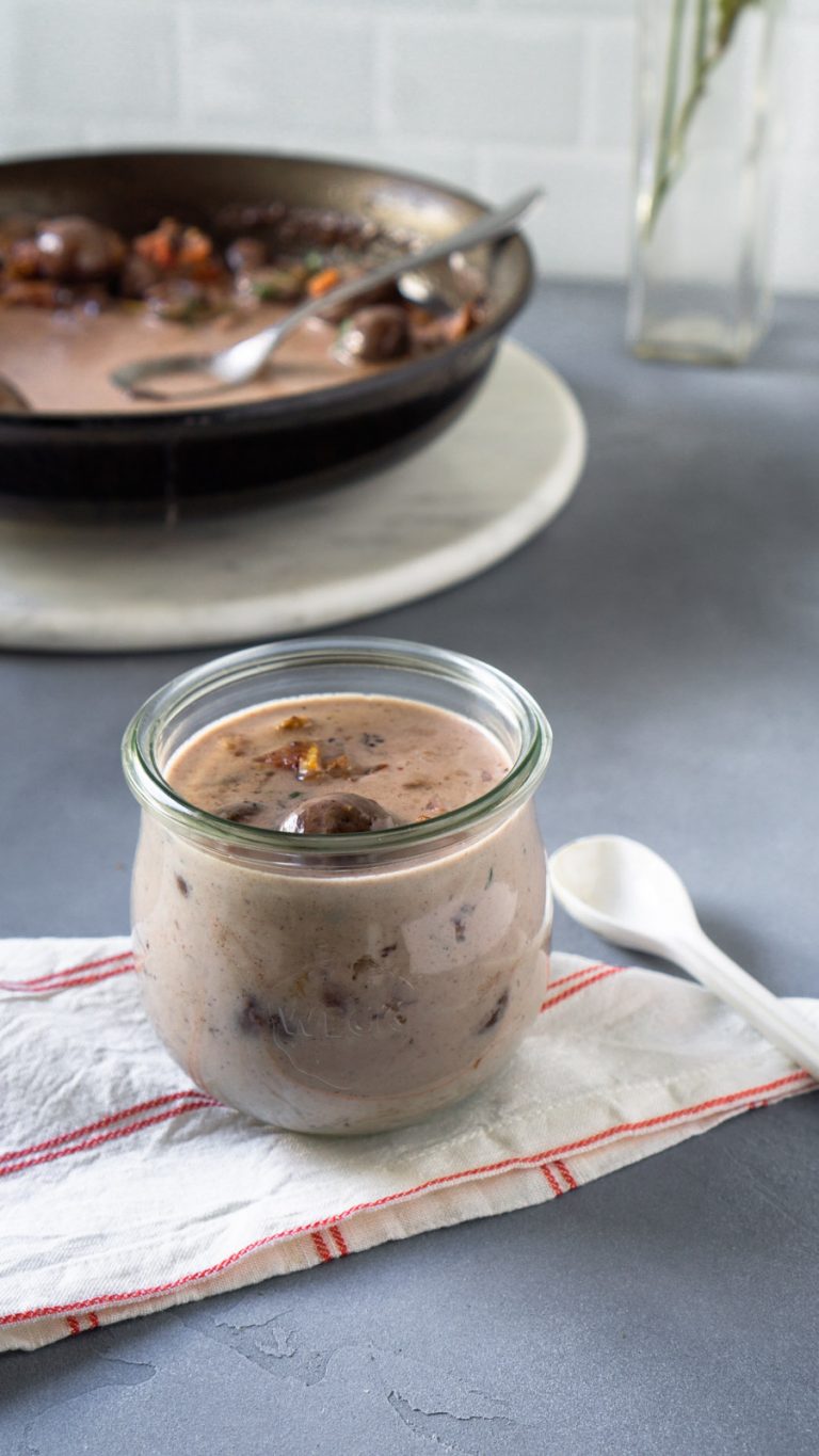 mushroom bacon gravy in a weck jar with a small white spoon