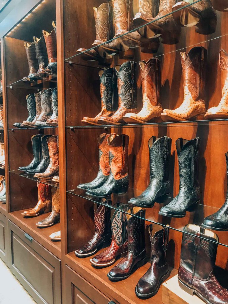 a wall lined with cowboy boots