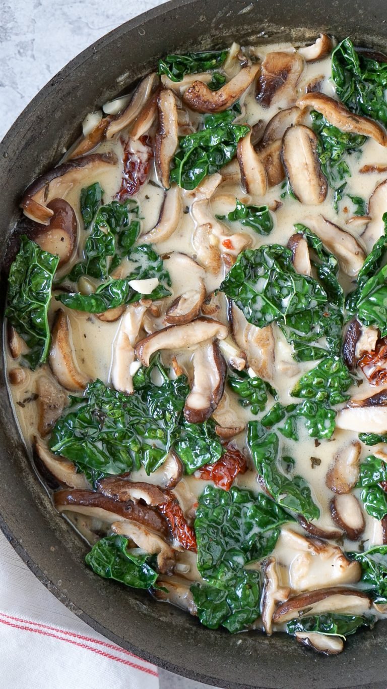 kale, mushrooms, and sun dried tomatoes in a cream sauce