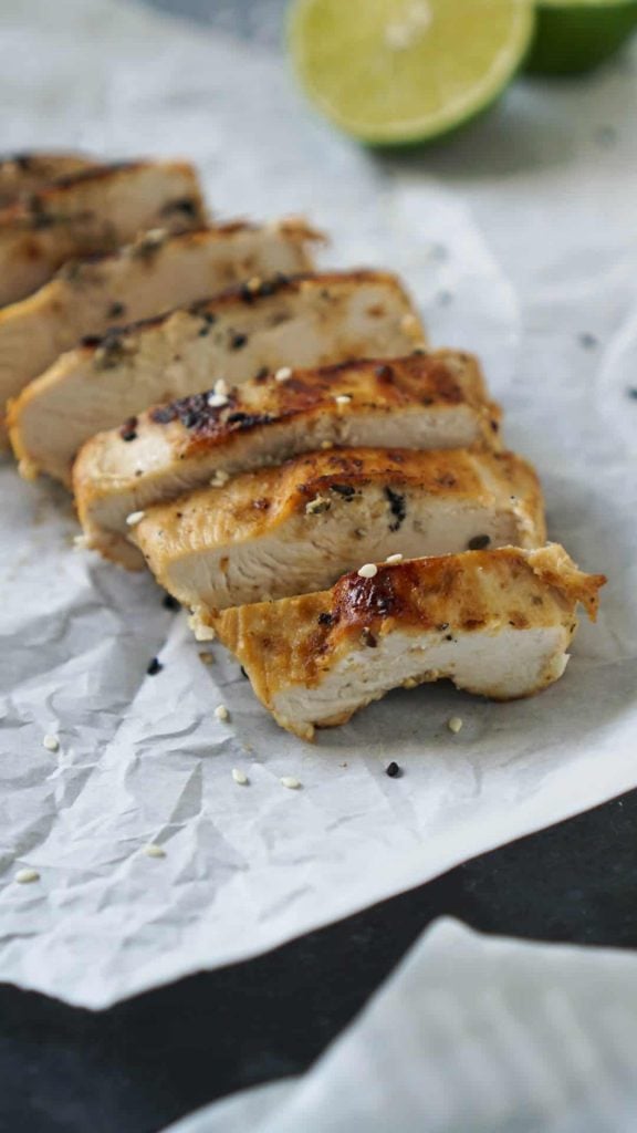 sesame ginger chicken sliced on parchment paper